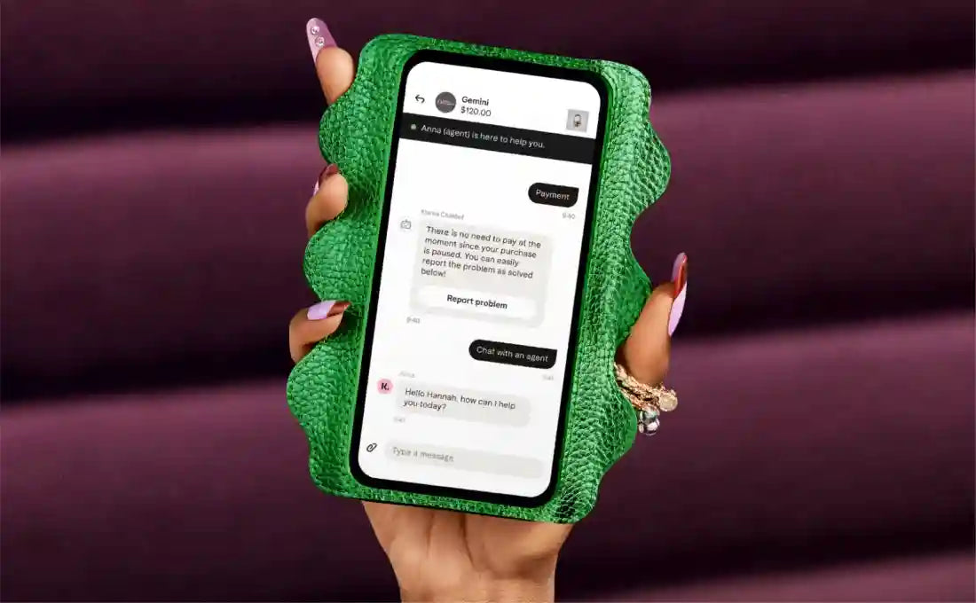 Ladies' hand holding mobile phone showing conversation with Klarna customer support on the screen; what a phone case!