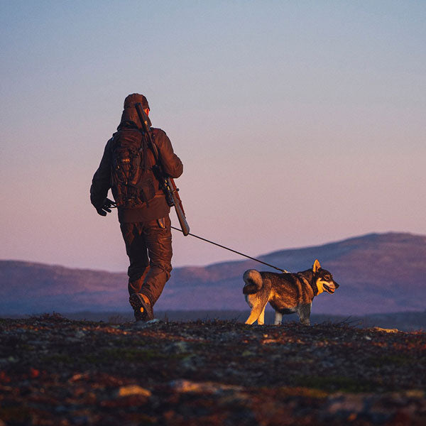 Mobile hero image of a man with a dog, walking heroically into the distance